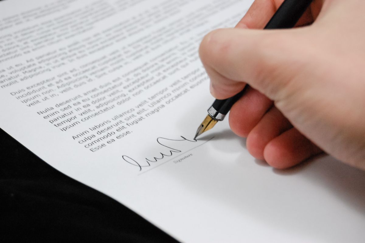 Commercial contract and signed agreement documents on a desk